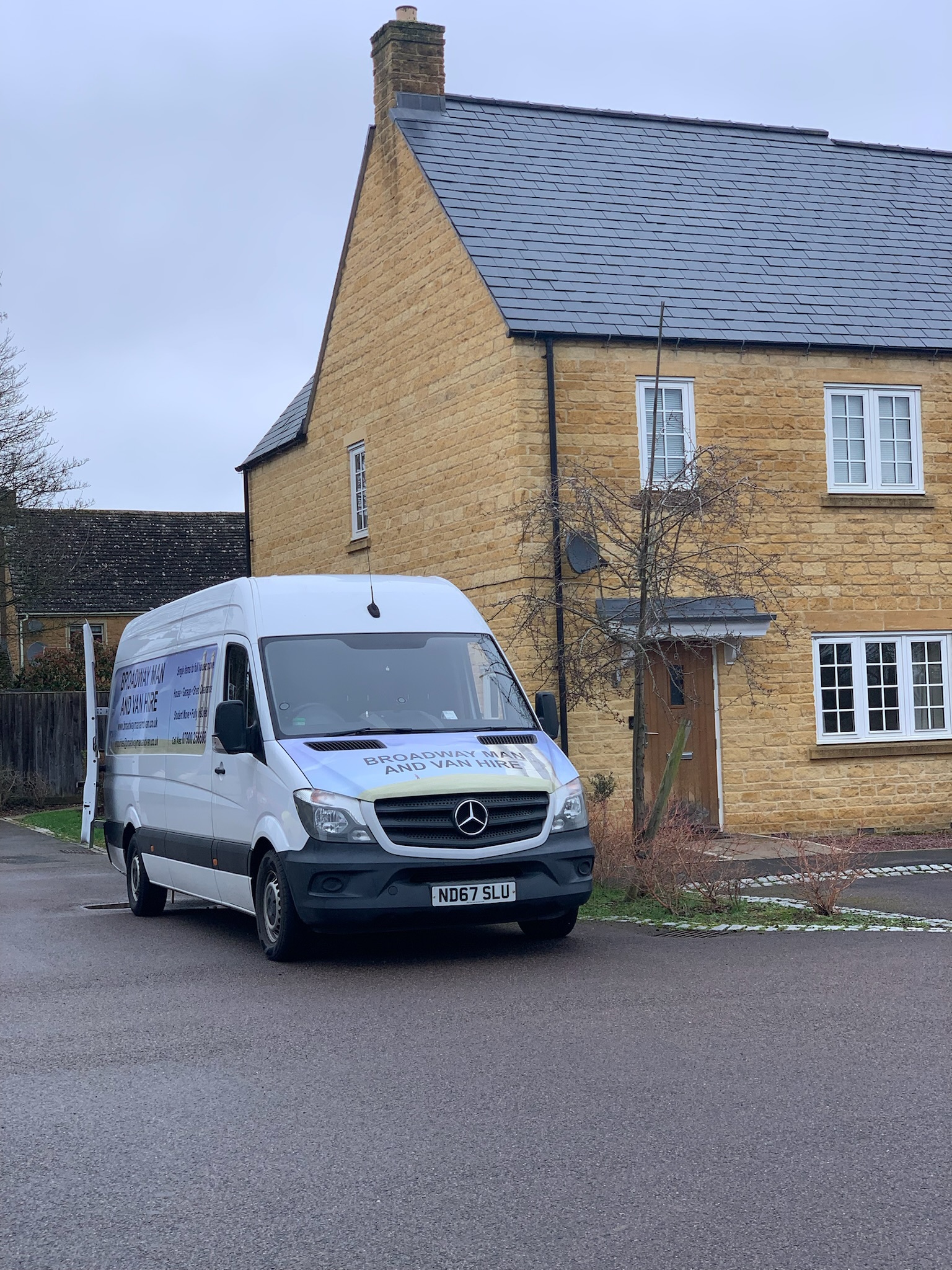 big white van parked next to a house